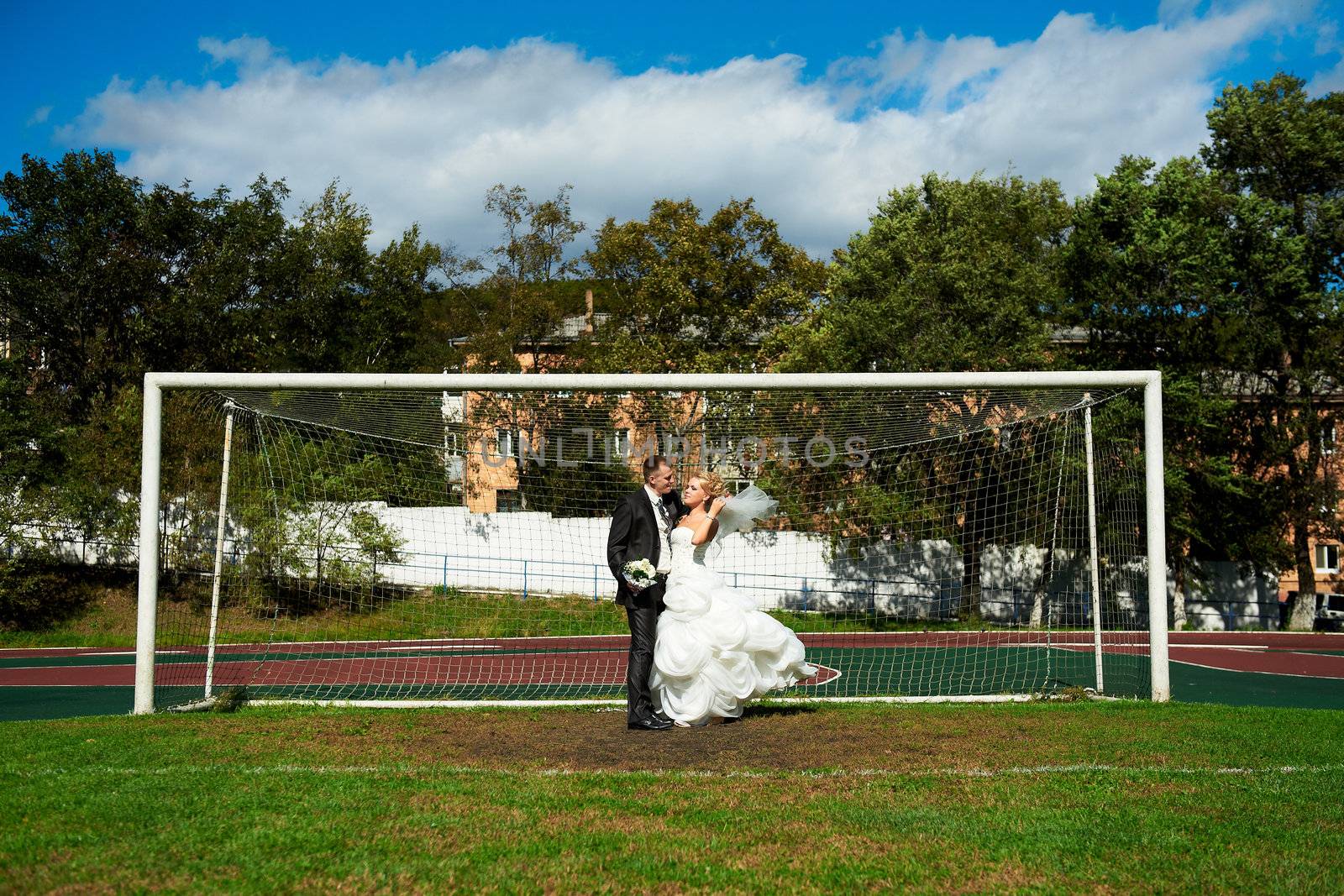 Bride and groom on the football field