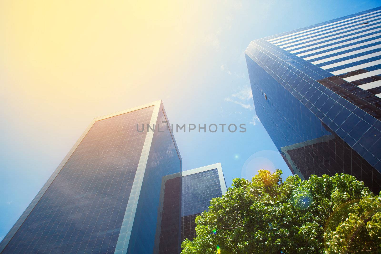 business buildings and blue sky with sunbeams