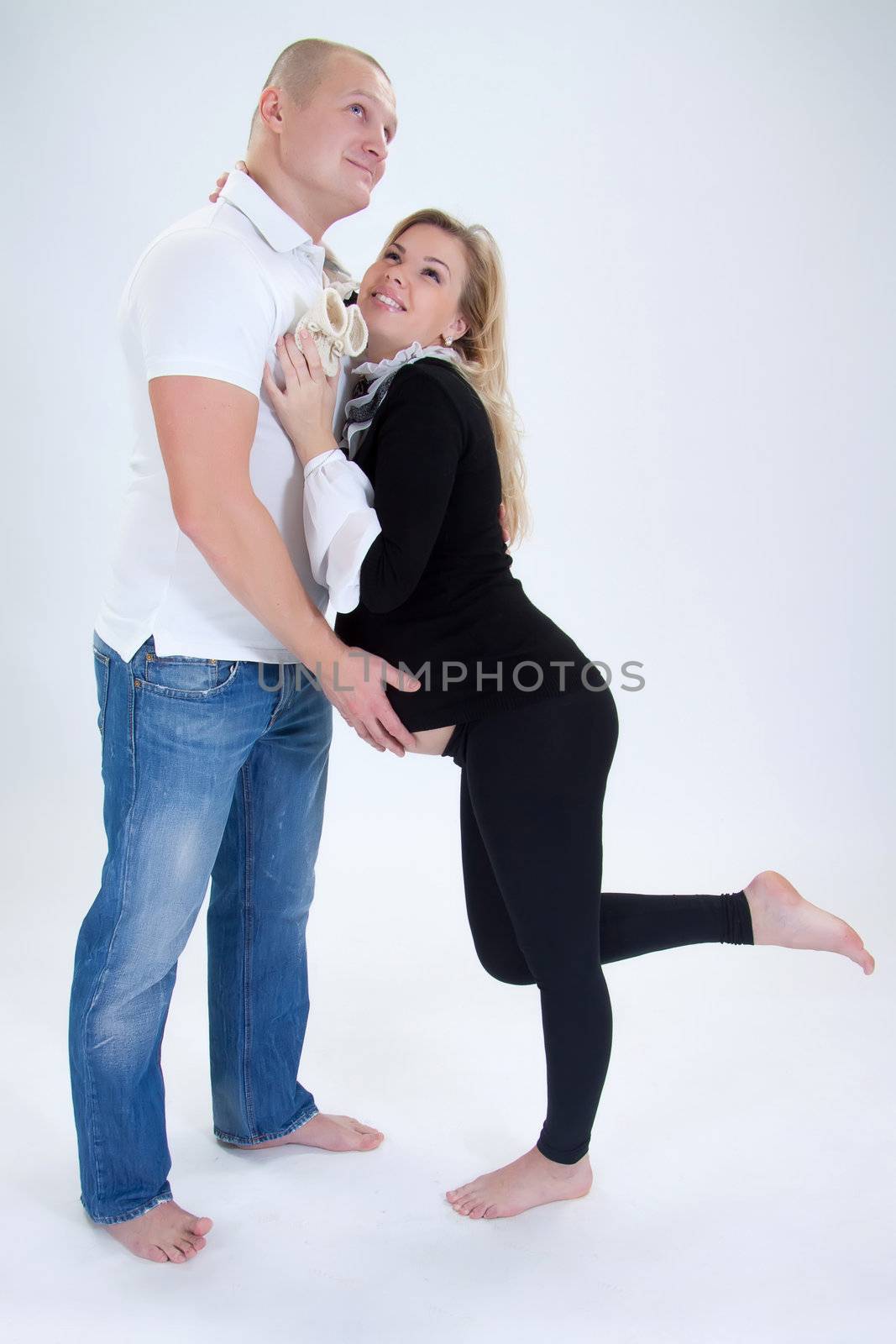 Happy parents with self-made child's boots smiling. 