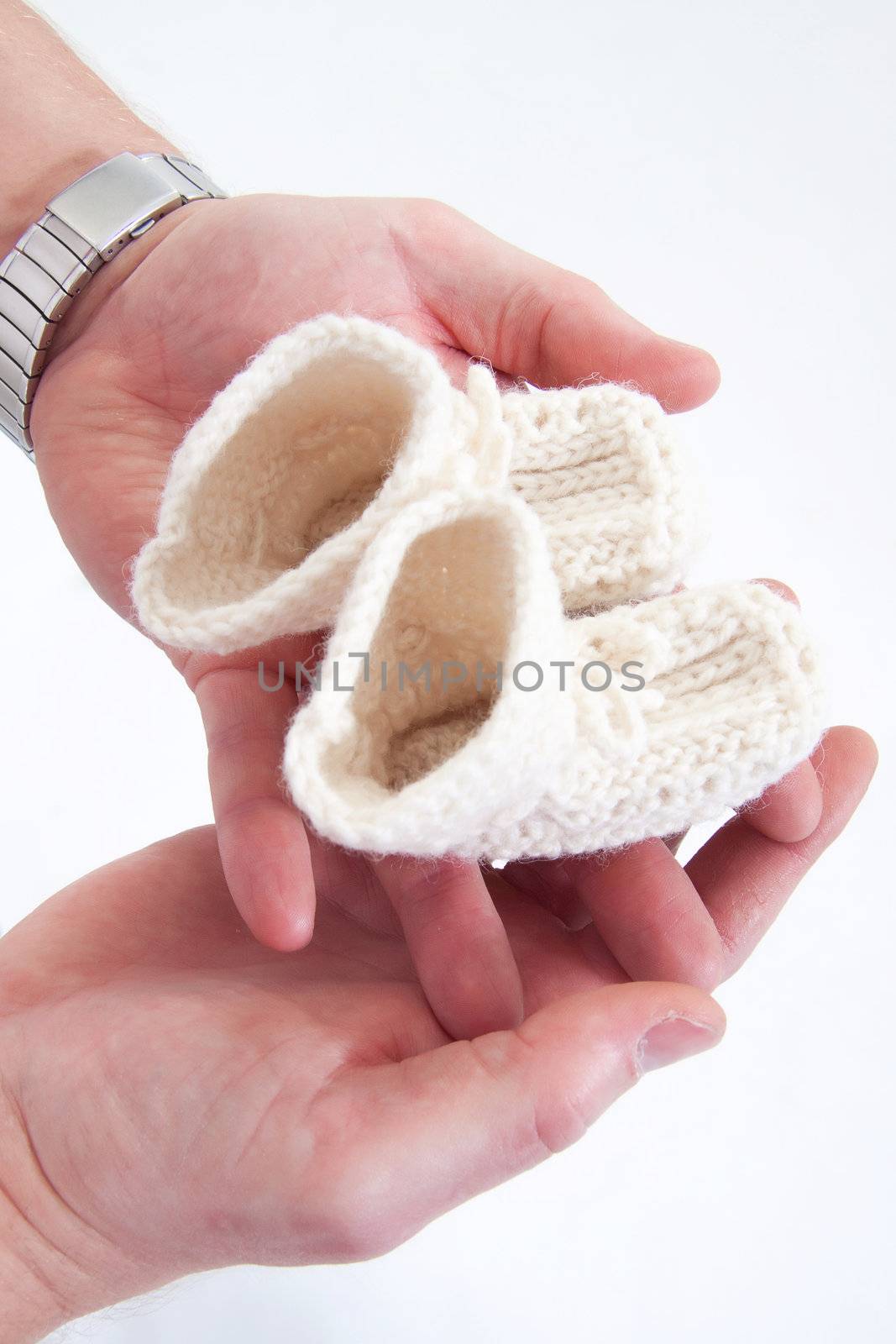 Parents holding self-made child's boots in their hands. 