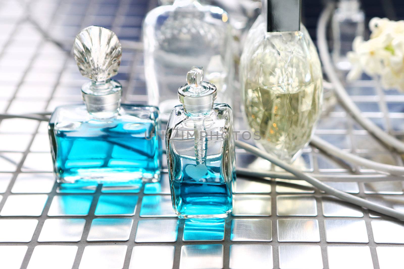 Perfume with beautiful flowers on the table