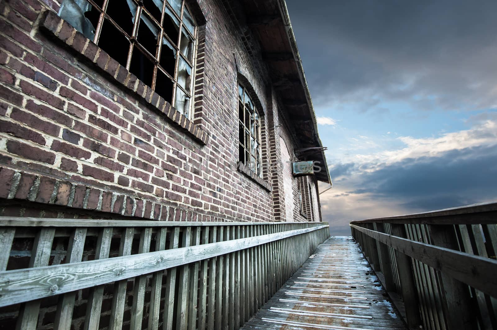 Old warehouse with broken windows and a walkway