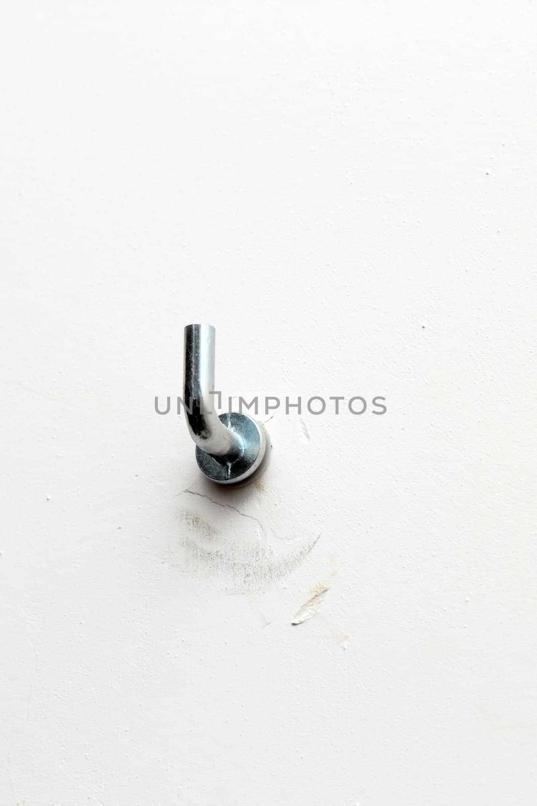 painting hanger on white wall by taviphoto