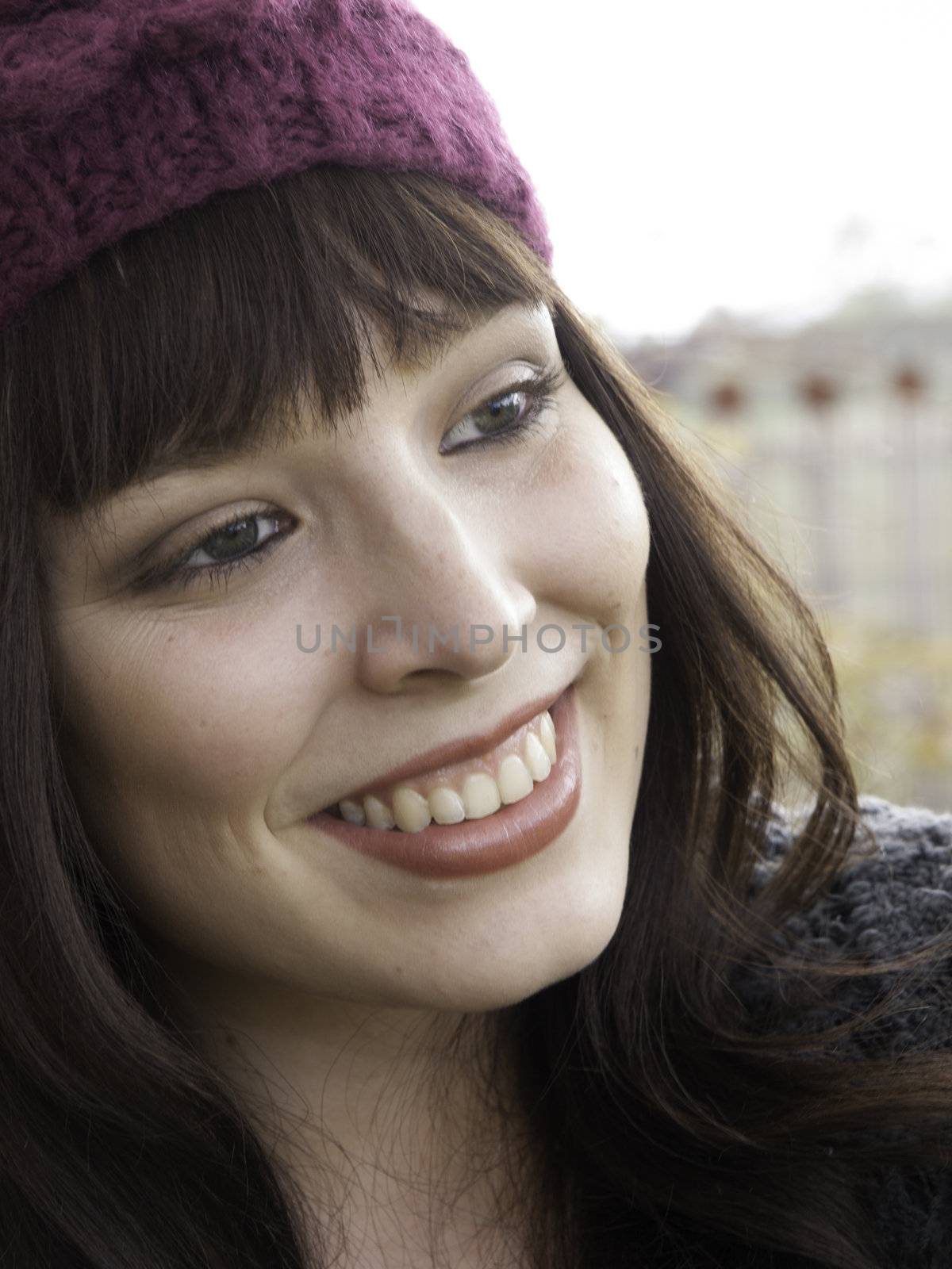 Pretty young woman in pink wooley hat