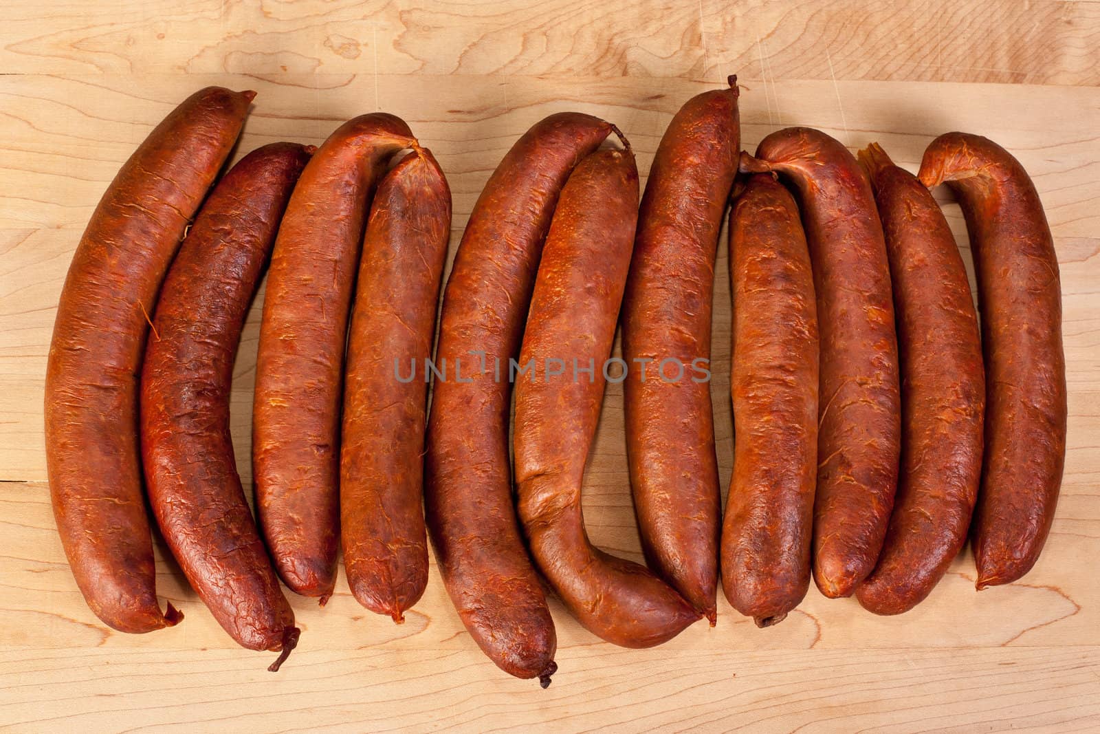 Fresh home made sausages on wooden background