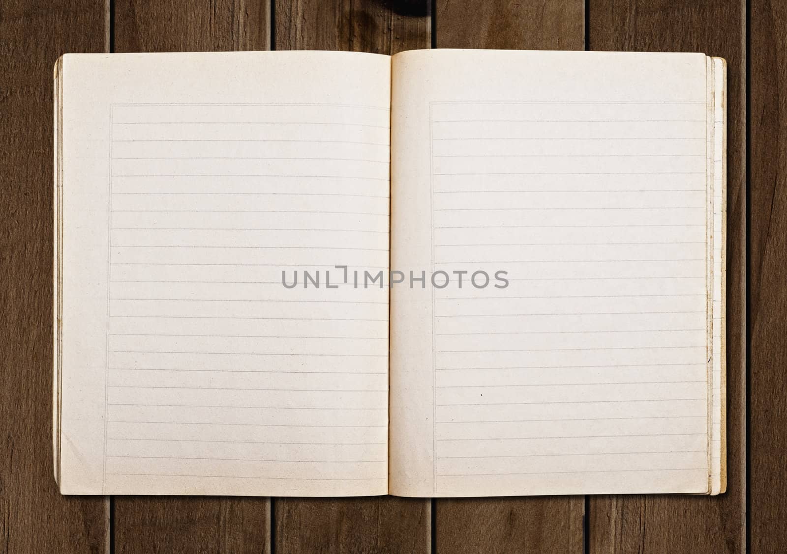 Open old notebook on a wooden table.