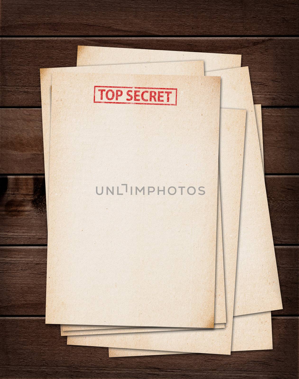 top secret files on wooden table.