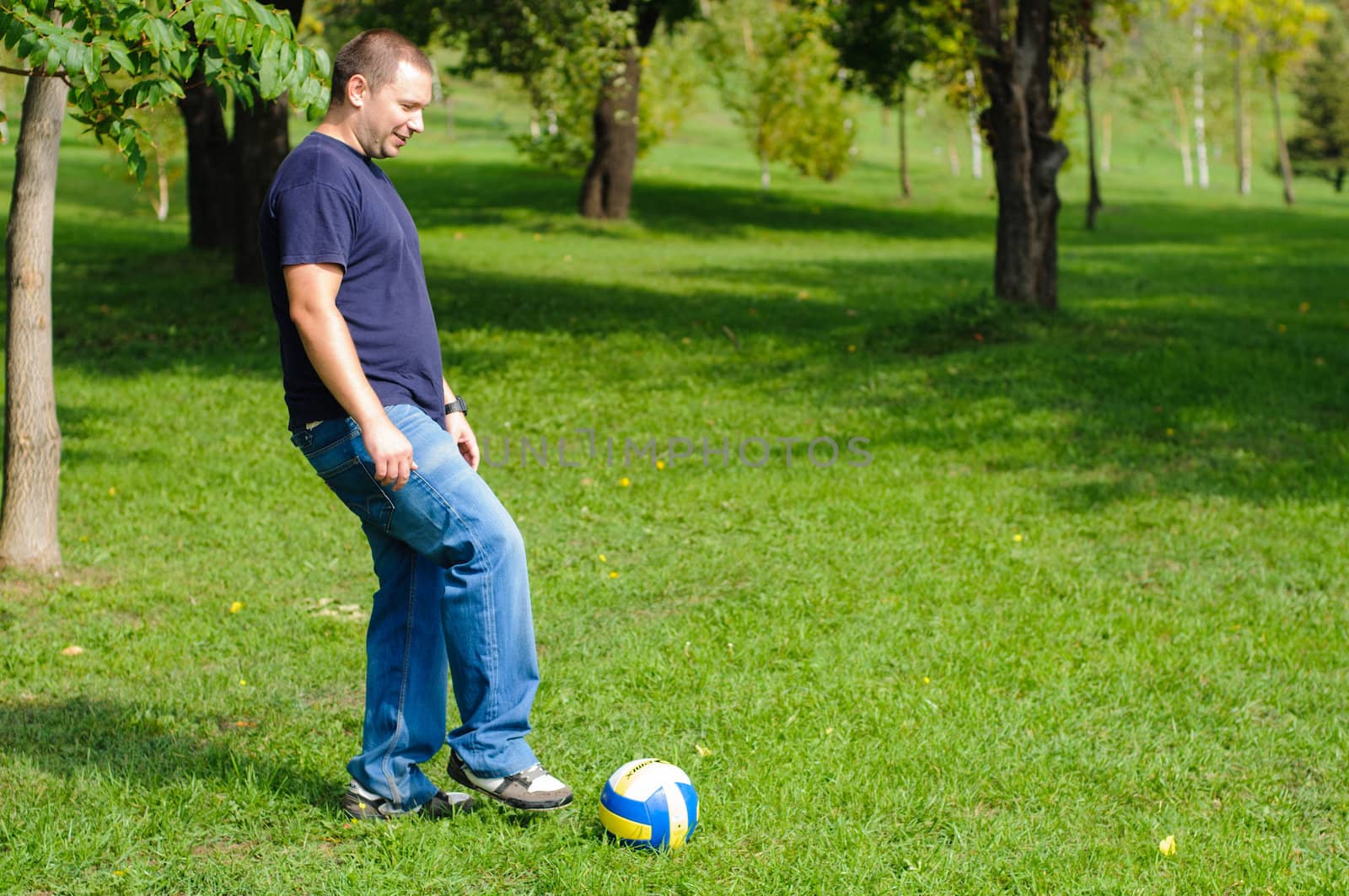 Young man playing football by nvelichko