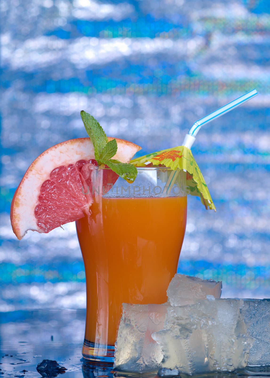 tropical coctail drink with ice cubs,closeup