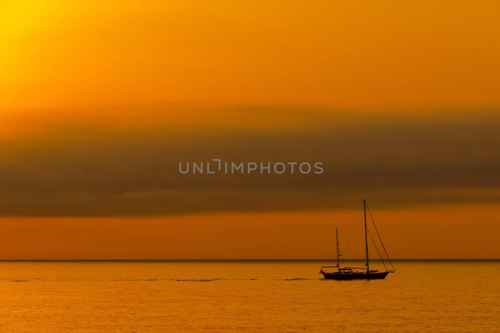 Dawn sailboat silhouette on ocean