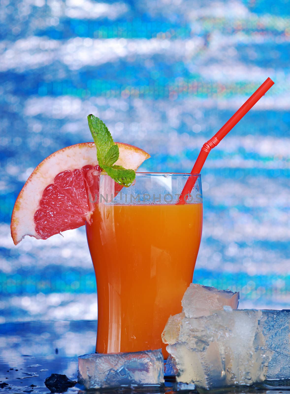 tropical coctail drink with ice cubs,closeup