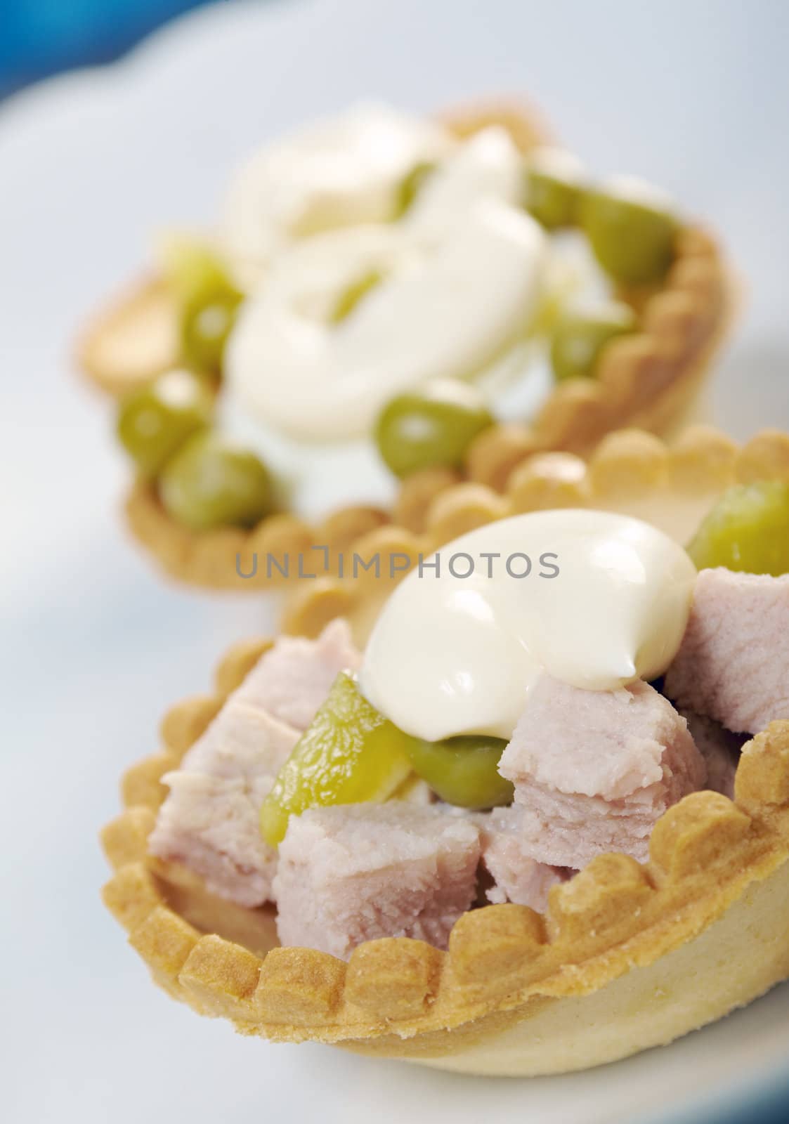 tartlet with salad on a white plate .Shallow depth-of-field