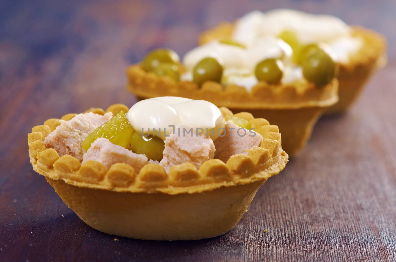 tartlet with salad on wooden board .Shallow depth-of-field