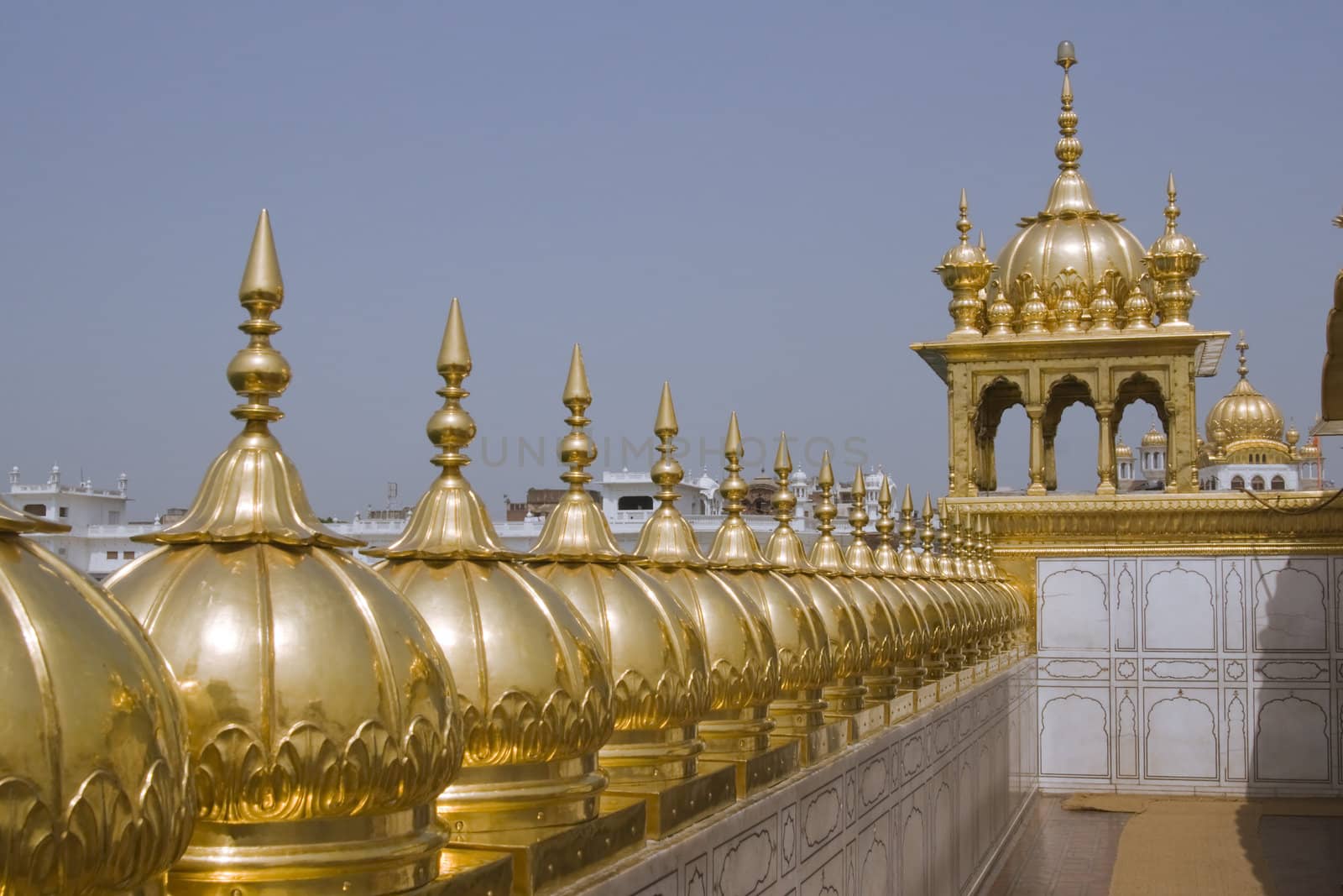 Golden Temple. Holiest shrine of the Sikh religion. Row of gold domes along the roof of the temple. Amritsar, Punjab, India.