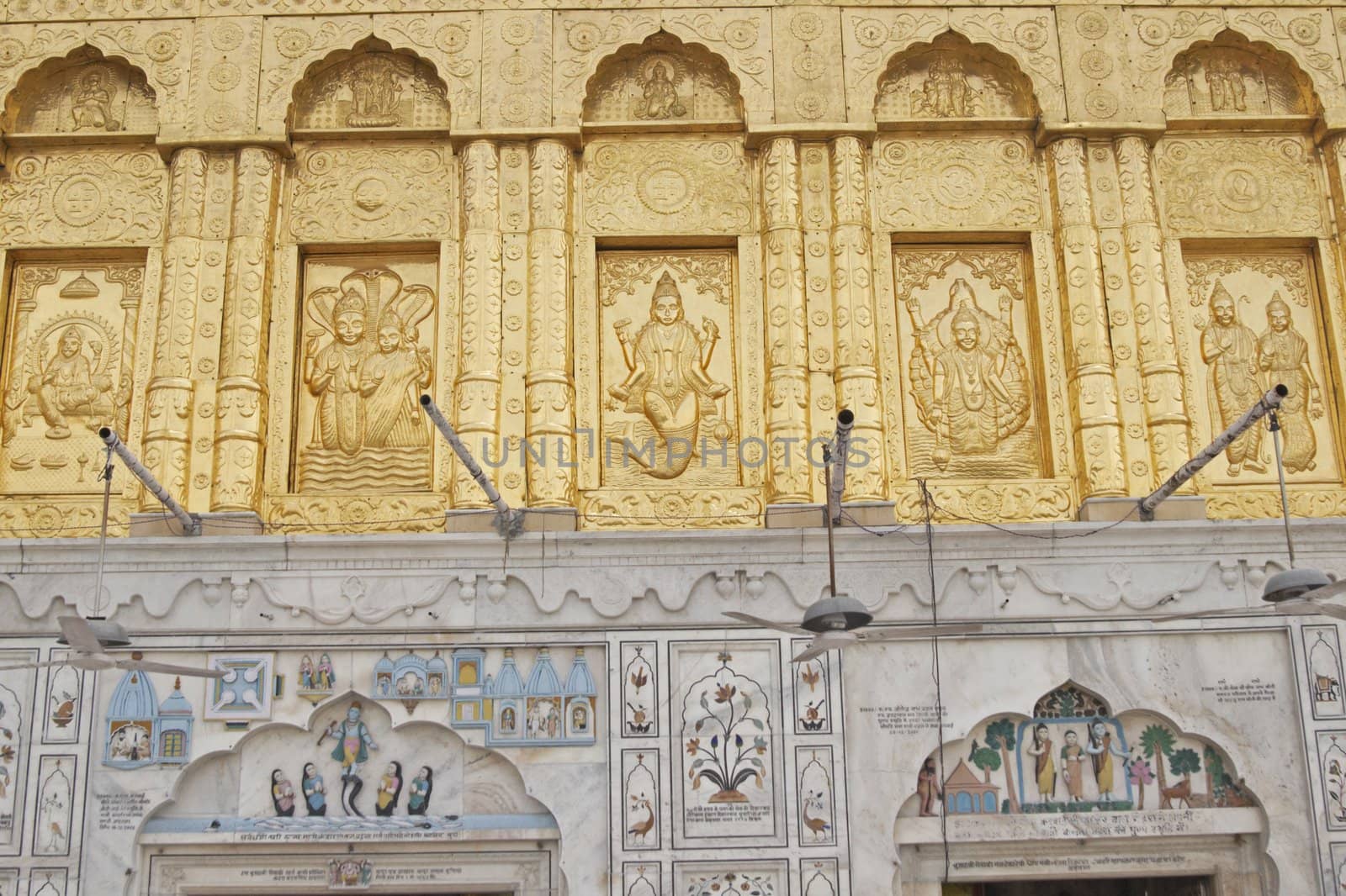 Durgiana Hindu Temple. Detail of ornate gold panel and inlaid mable decorating the front of a hindu temple. Amritsar, Punjab, India