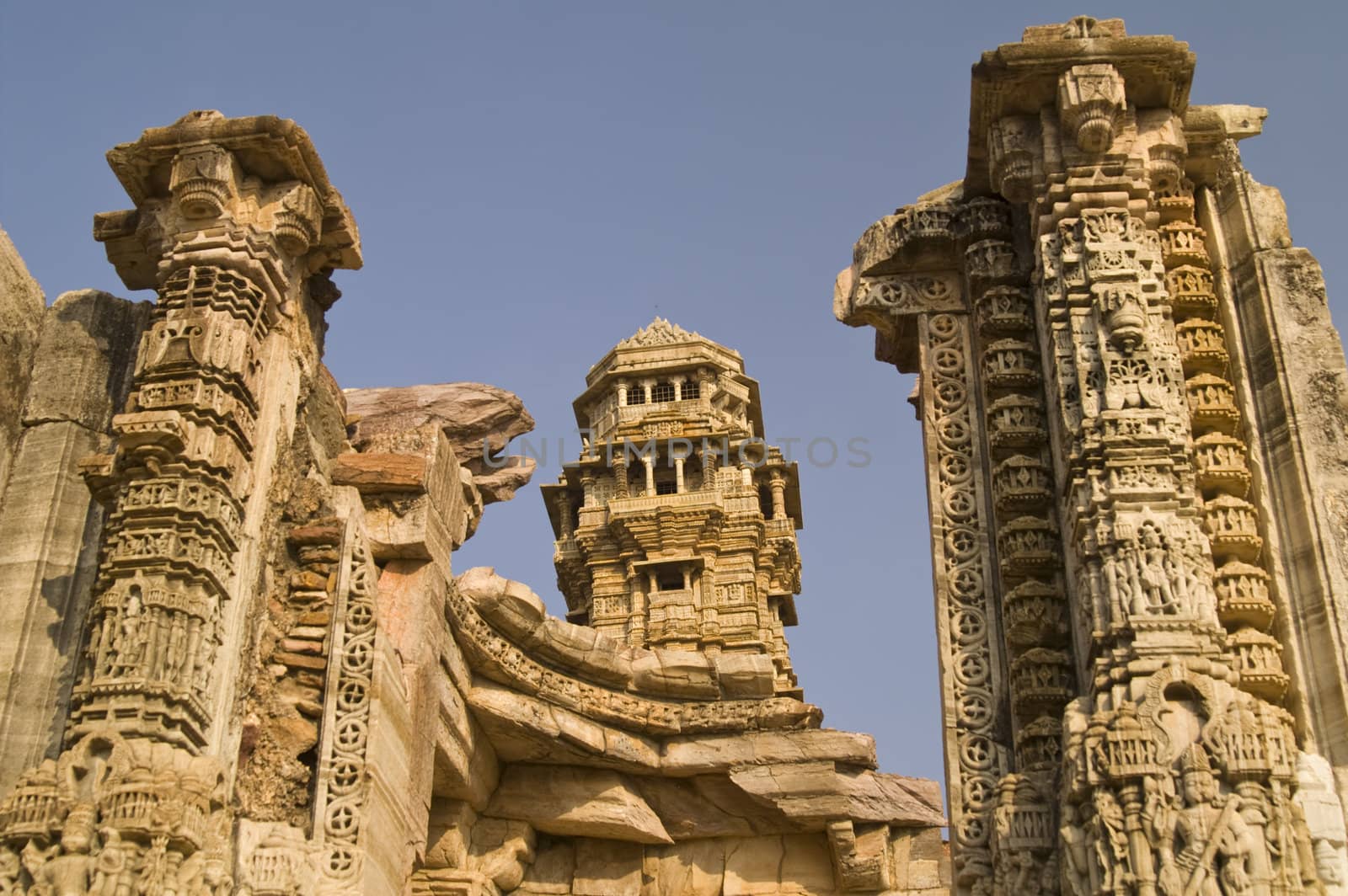 Ornate carved stone victory tower (Vijay Stambha) built to celebrate an ancient victory. Chittaugarh, Rajasthan, India.