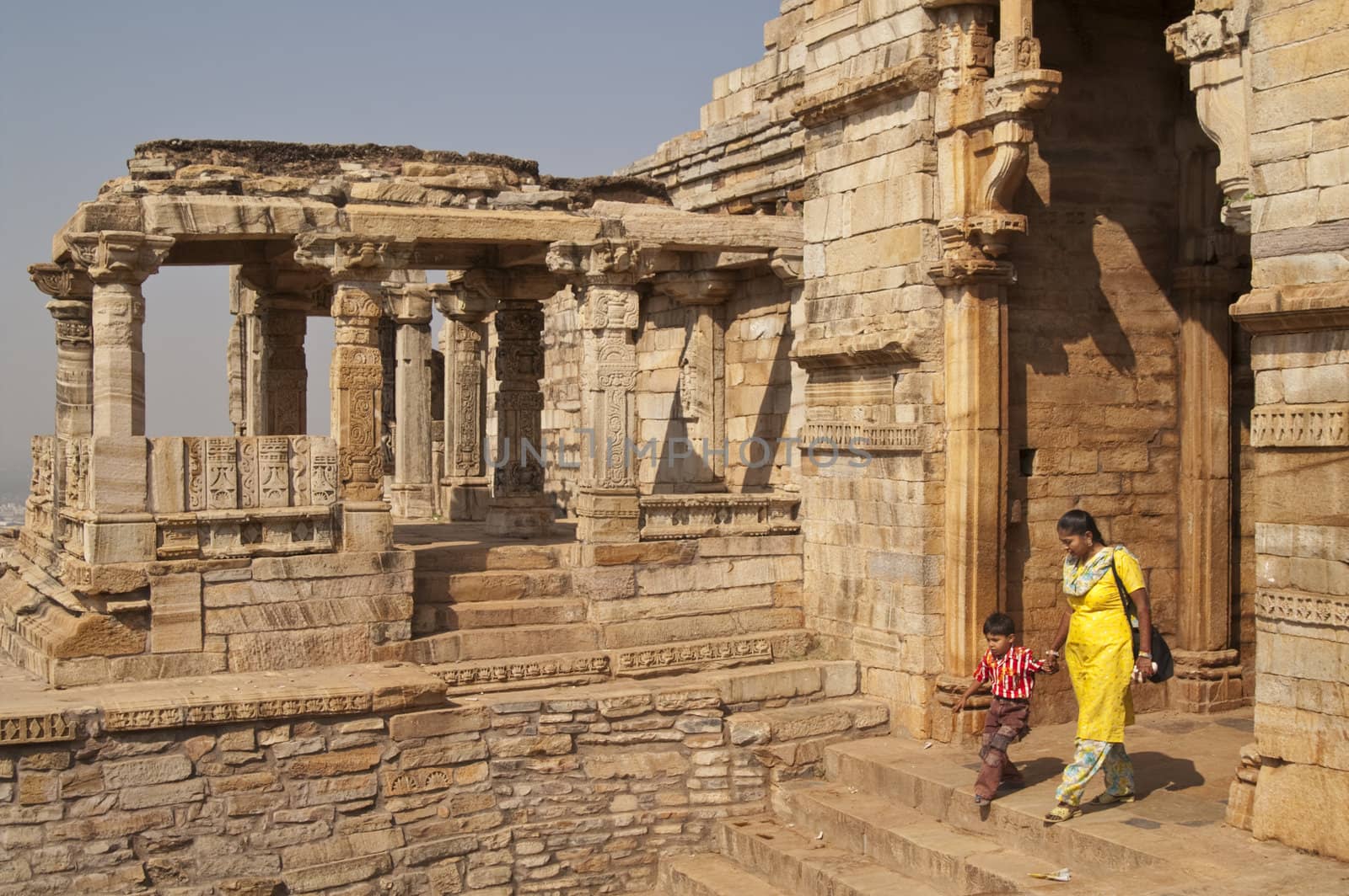 Indian woman and child exit from Hindu Temple in Chittaugarh Fort, Rajasthan, India