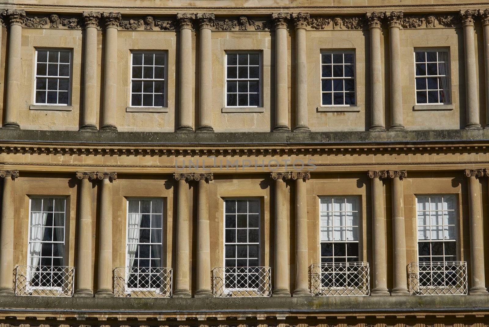 Windows in a curved terrace of Georgian Town houses in The Circus, Bath, England