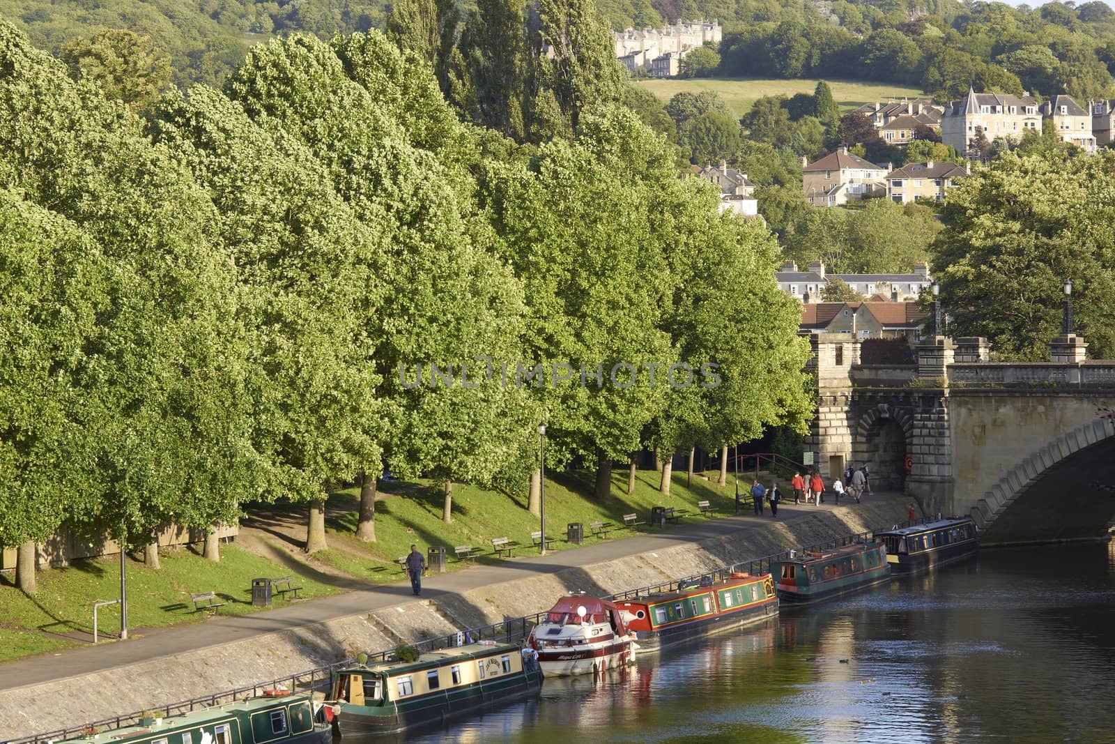 Canal boats moored on the River Avon in the centre of the historic city of Bath in Somerset, England