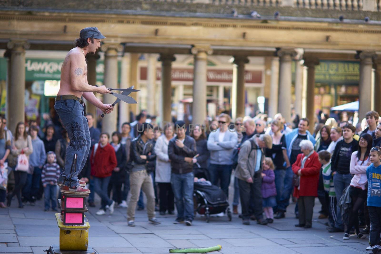Street artist juggling with knives in Abbey Churchyard, Bath, Somerset, England