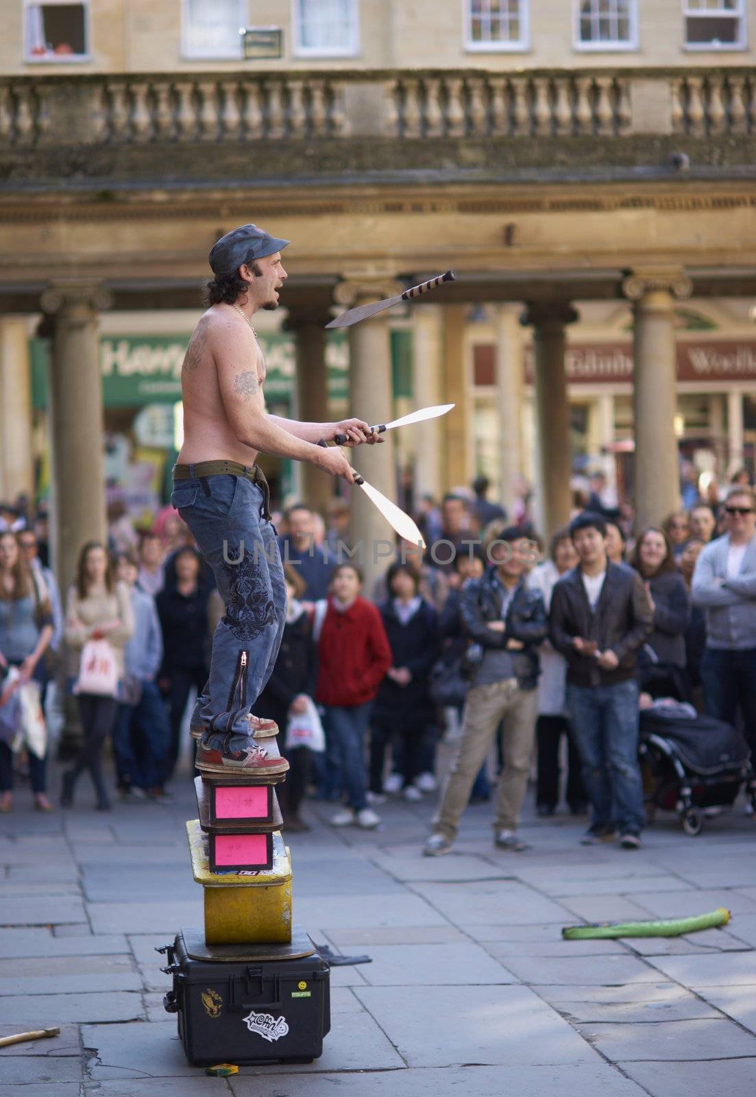 Street artist juggling with knives in Abbey Churchyard, Bath, Somerset, England