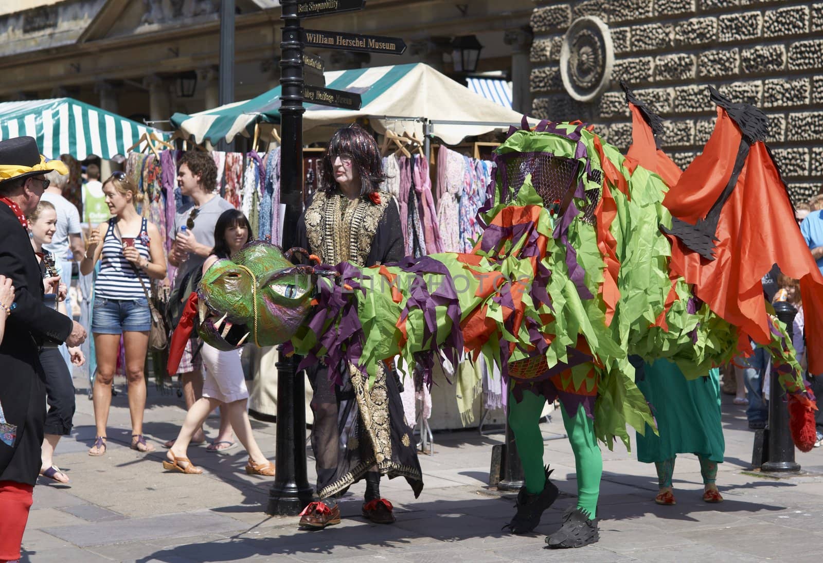 Street artists re-enacting the story of St George and the dragon in Bath, Somerset, England as part of the St Georges Day celebrations.