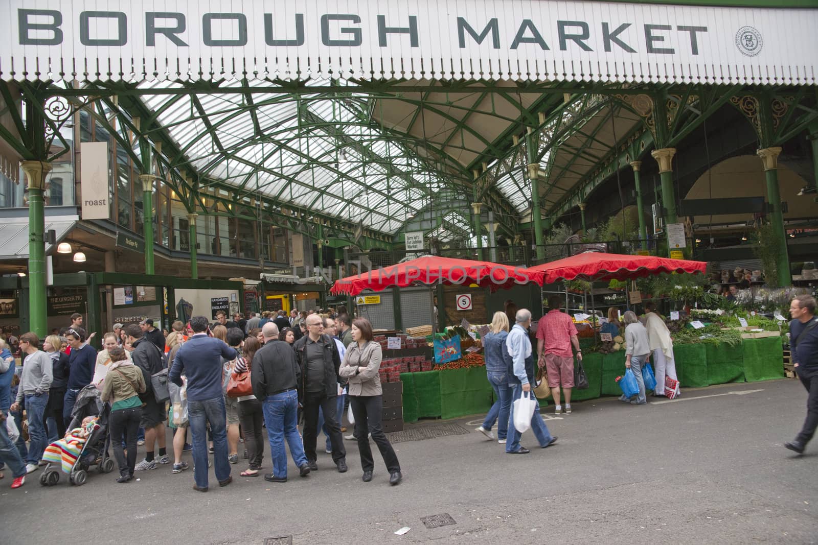 Crowds of at the historic Borough Market in Southwark, London, England.