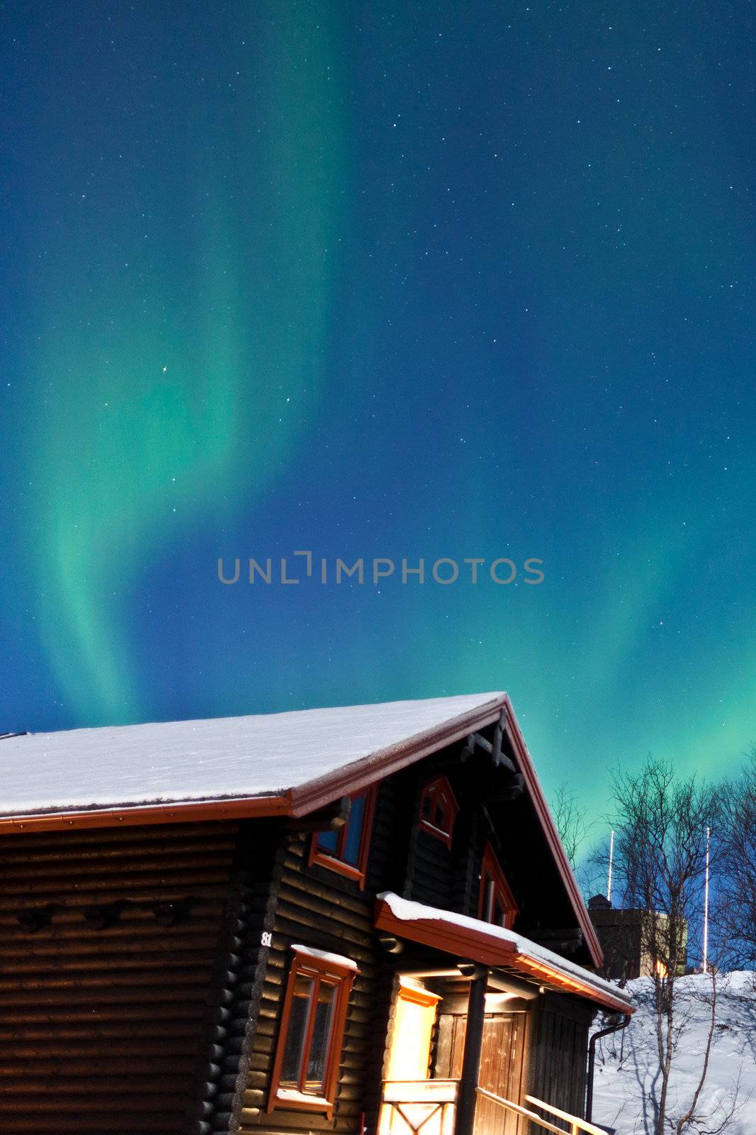 Northern Lights (Aurora Borealis) above a cabin by jamenpercy
