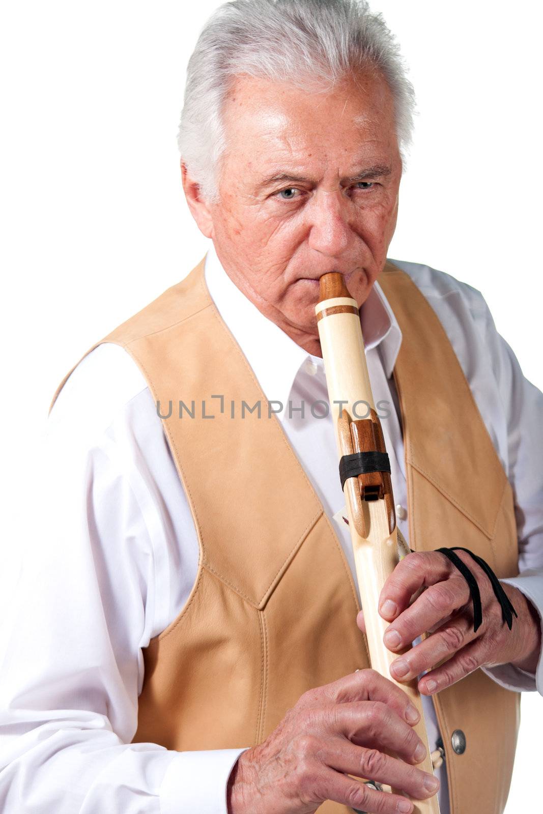 Elderly senior male playing native american flute by GunterNezhoda