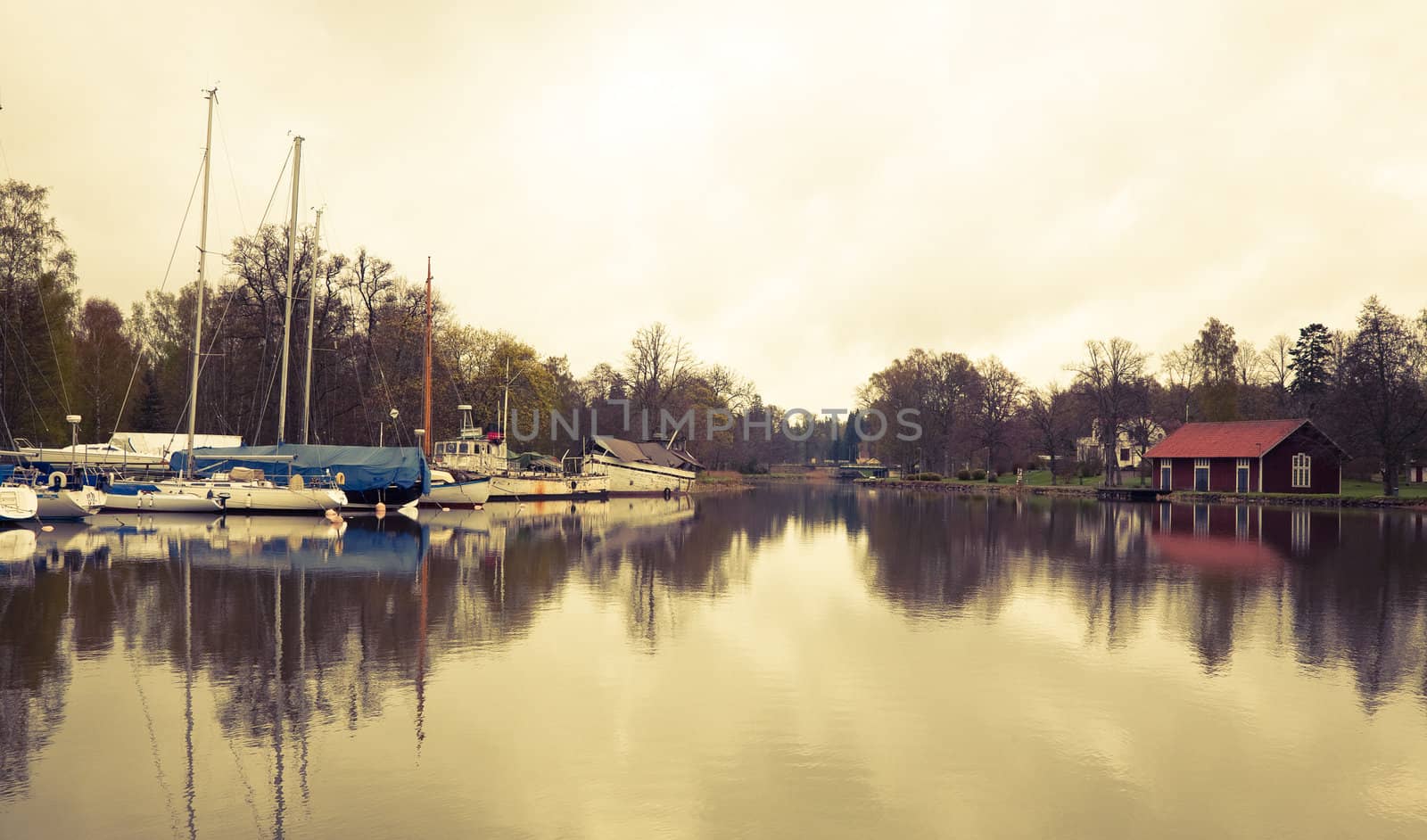 Tranquil scenery from the Gota Canal Sweden. Cross processed to give a retro look. Space for text.