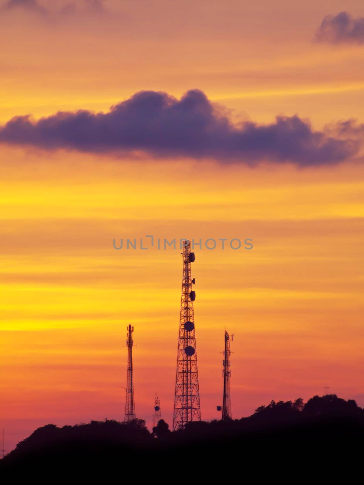 Golden sky with telecommunication tower on top of mountain