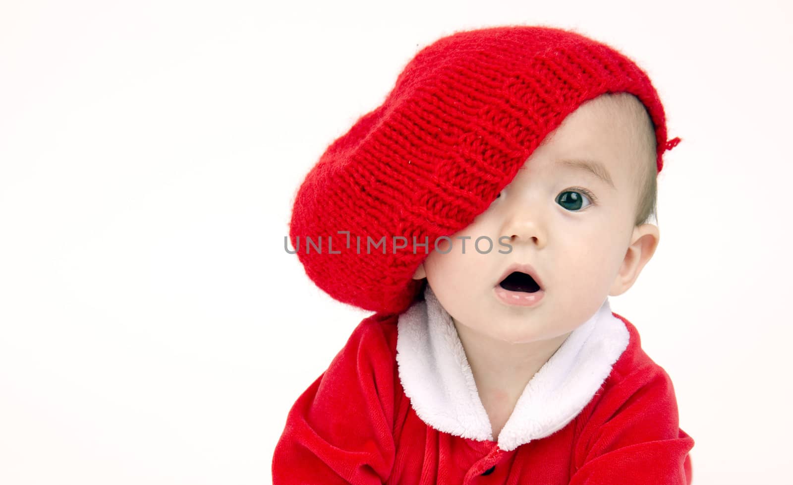 Infant Boy Sits lOOKING under his red hat by ChrisBoswell
