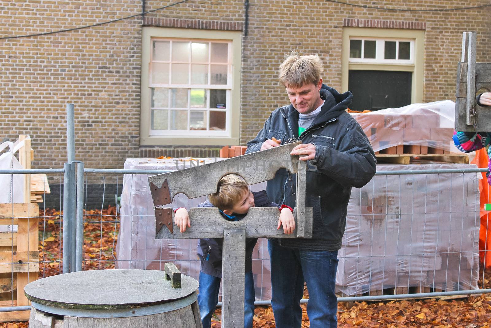 Father shows his son device pillory in the Dutch suburb. Netherl by NickNick