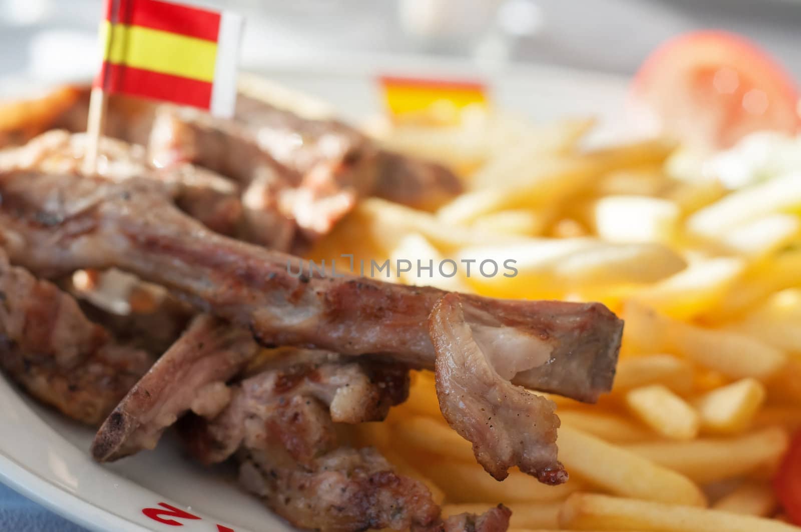 French fries and ribs. Shallow depth of field