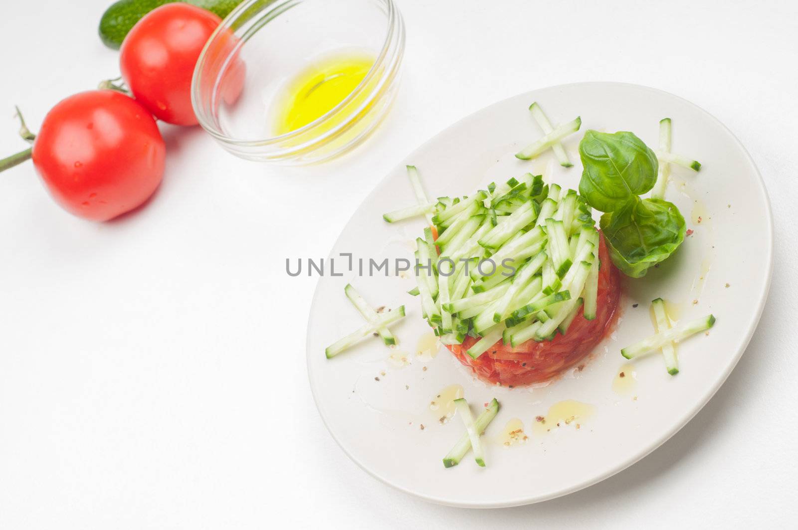 Tomatoes, olive oil and salad on the plate