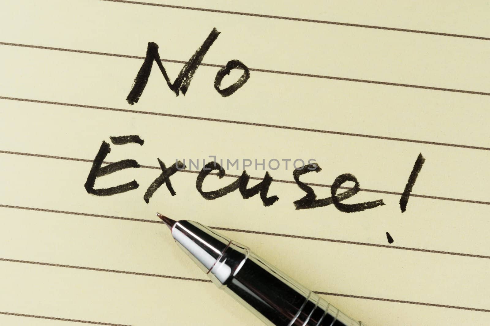 No excuse words written on lined paper with a pen on it