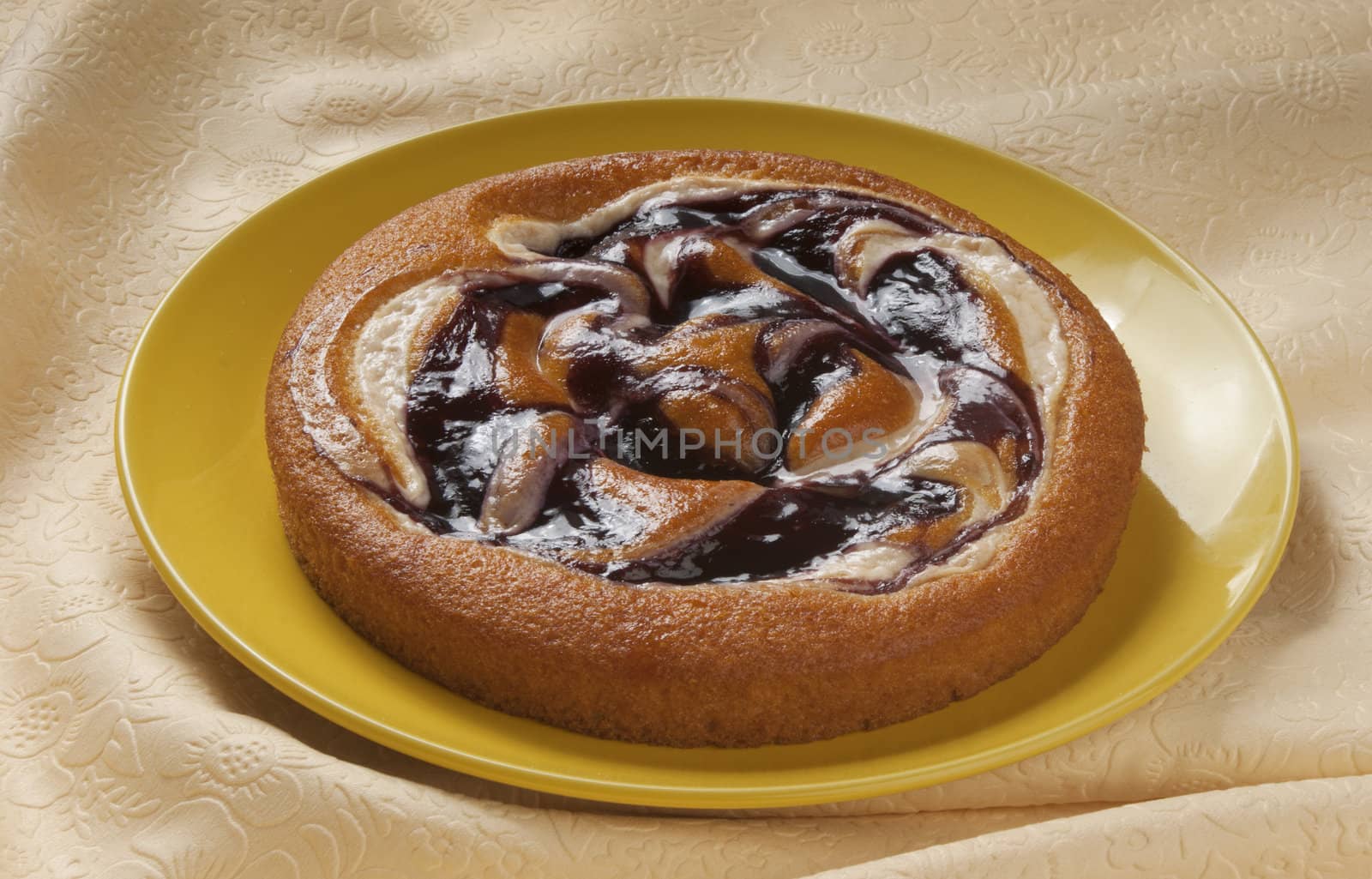 Bilberries cake on the yellow plate on the tablecloth