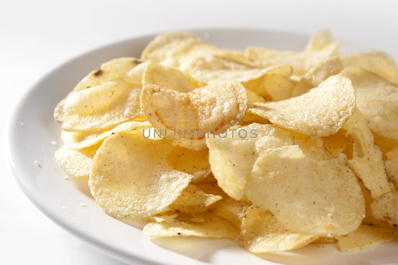 Some potato chips on the white plate