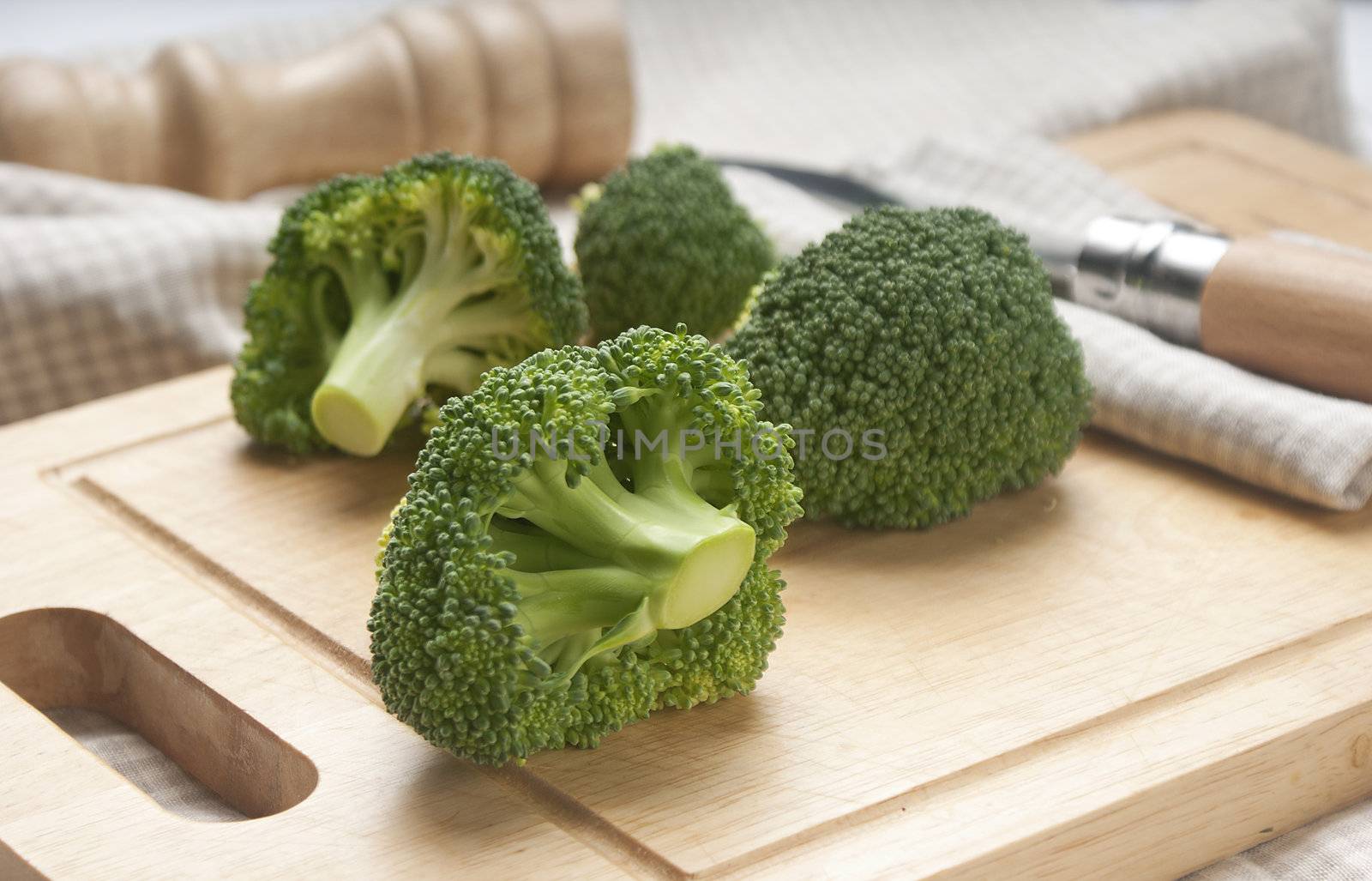 Some pieces of broccoli on the wooden board