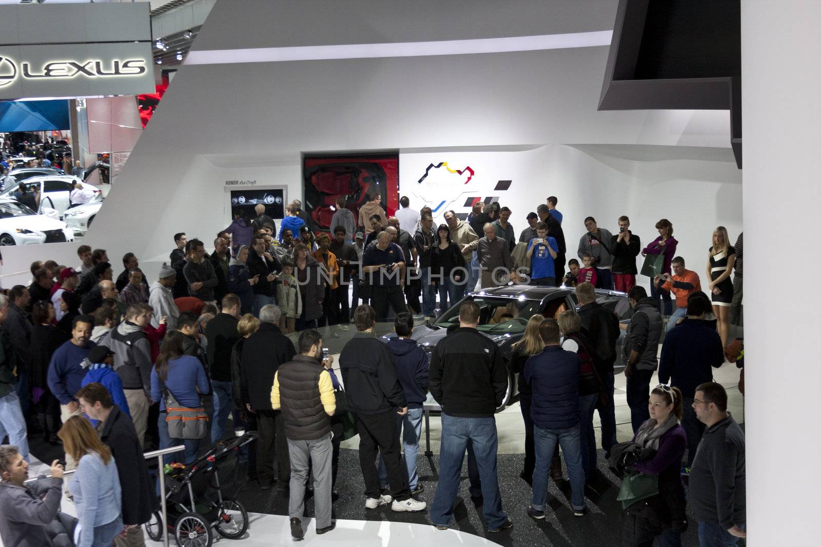 DETROIT - JANUARY 27 :The crowd gathering around the new 2014 Chevrolet Corvette stringray C7 at The North American International Auto Show January 27, 2013 in Detroit, Michigan. 