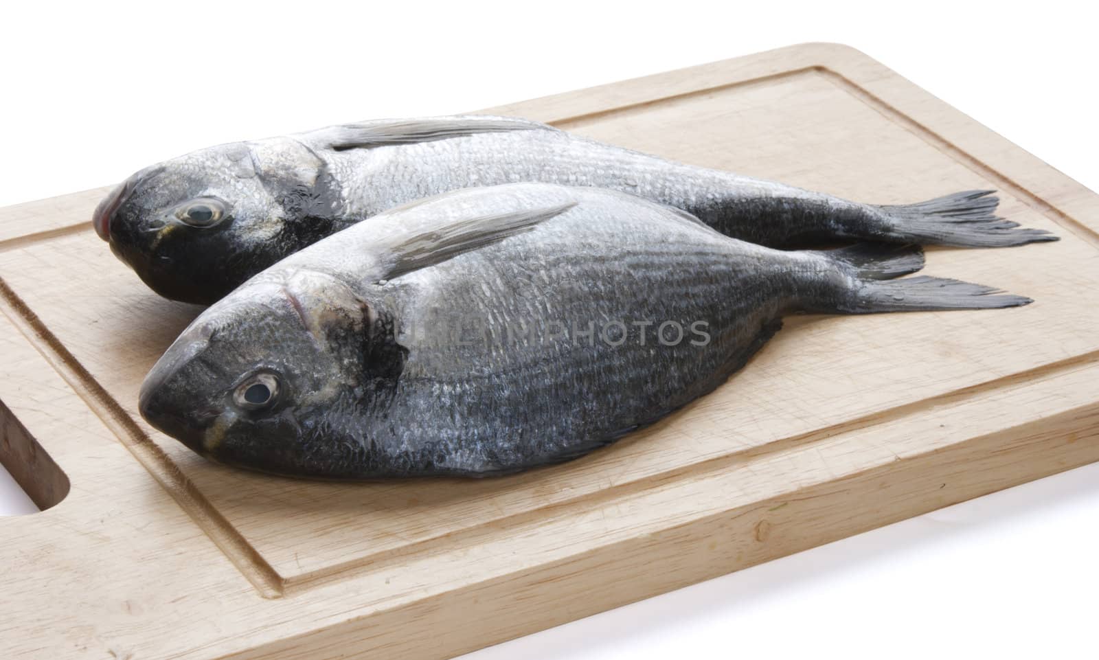Two Sea Breams on the wooden board