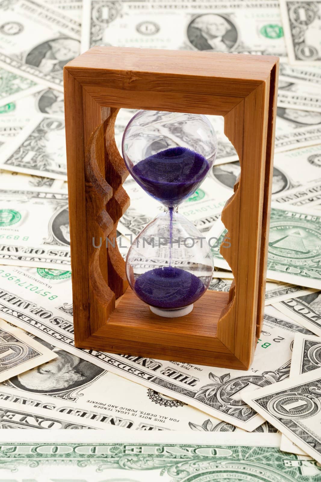Hourglass on a layer of paper money