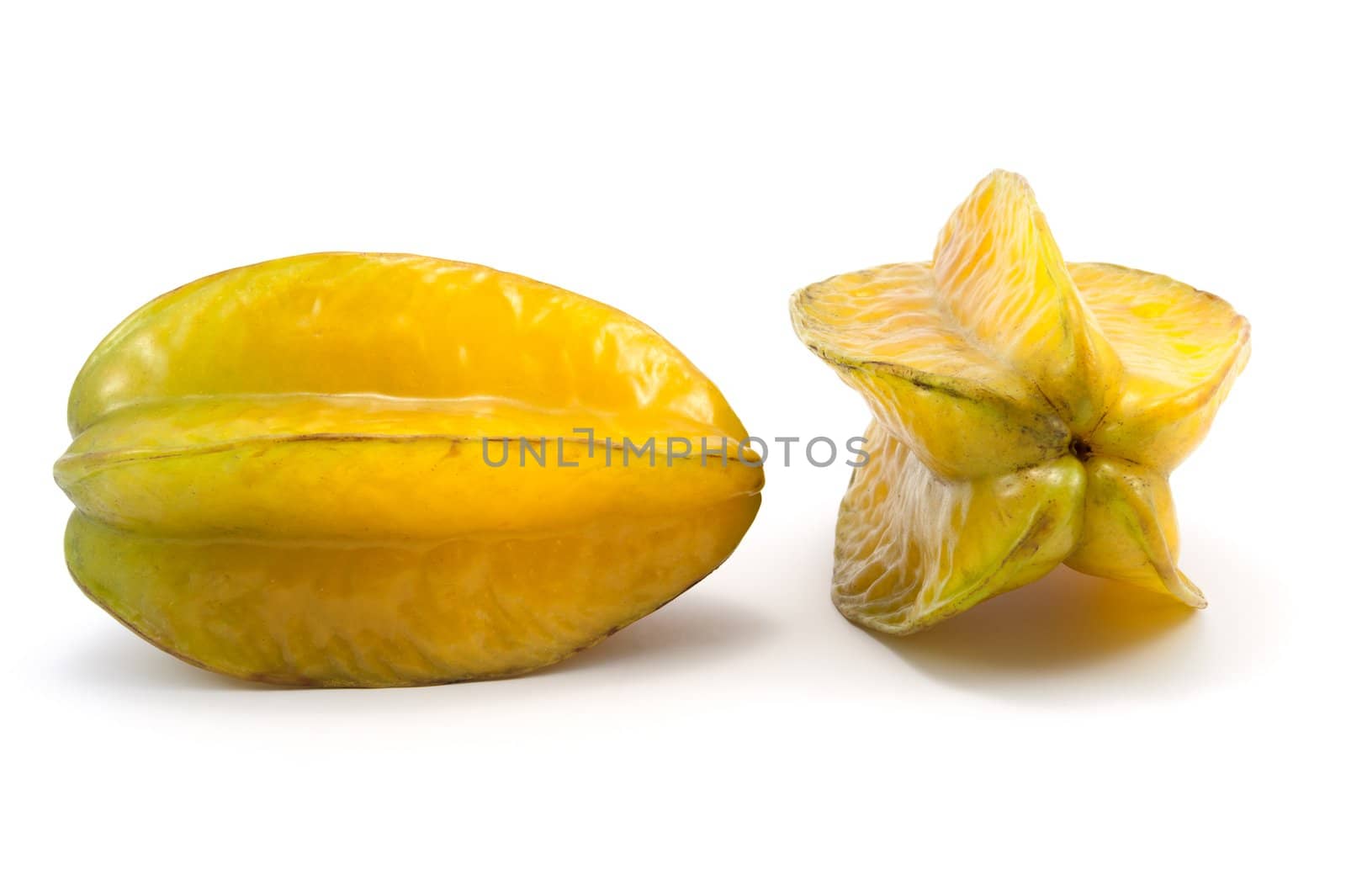 Two carambola fruits on white background
