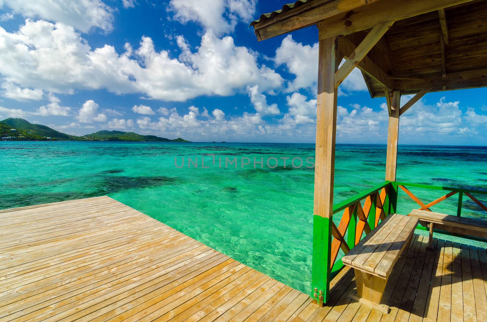 Wooden dock in Caribbean sea with beautiful turquoise and blue water in San Andres y Providencia, Colombia