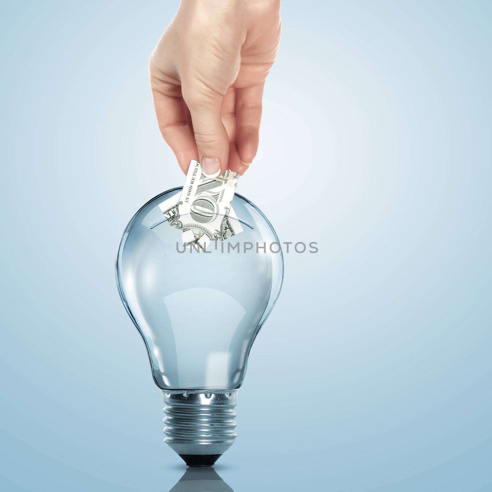 Hand and money inside an electric light bulb