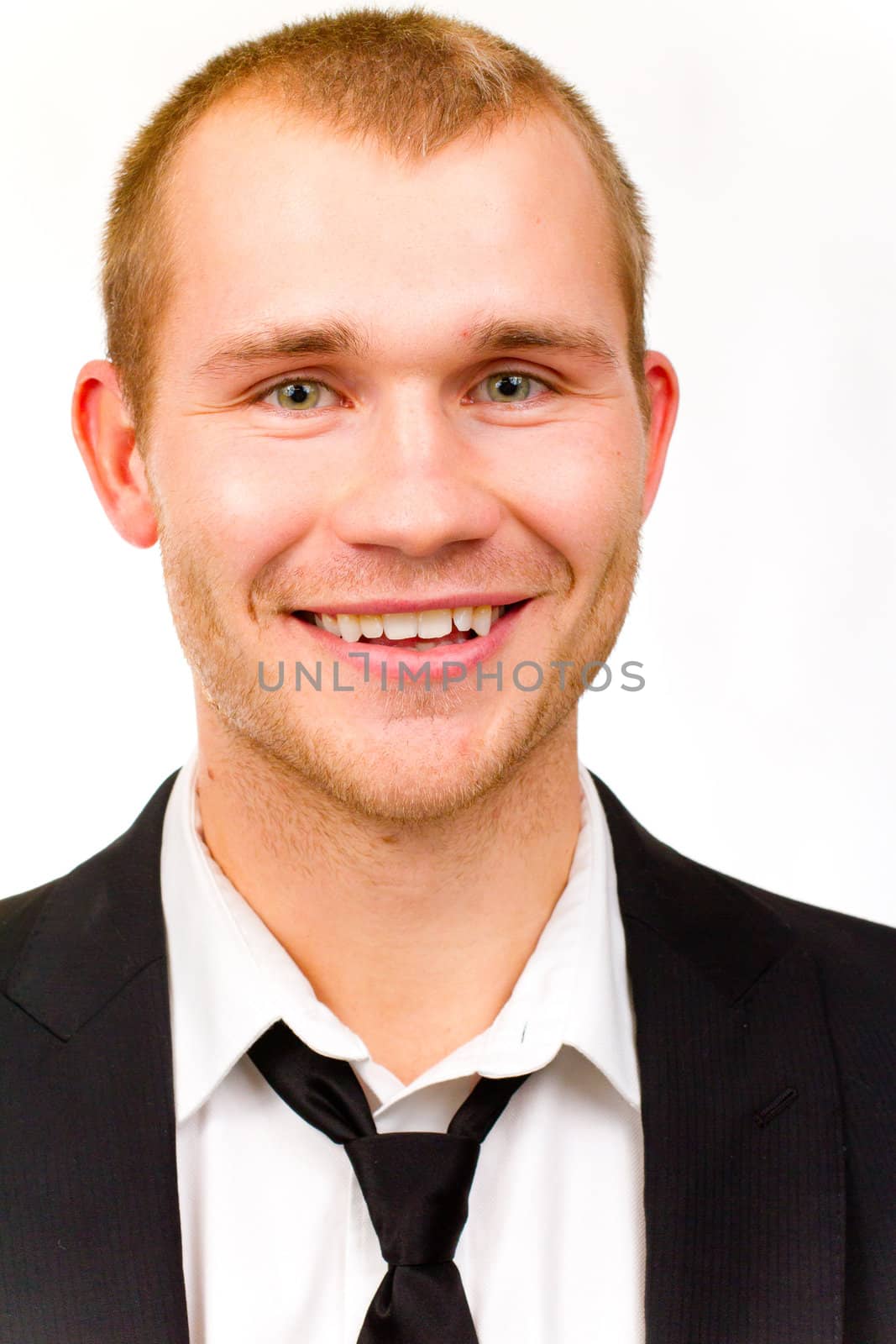 This handsome groom is isolated against a white background in the studio to create a portrait of a man that could be getting married or could be a business person.