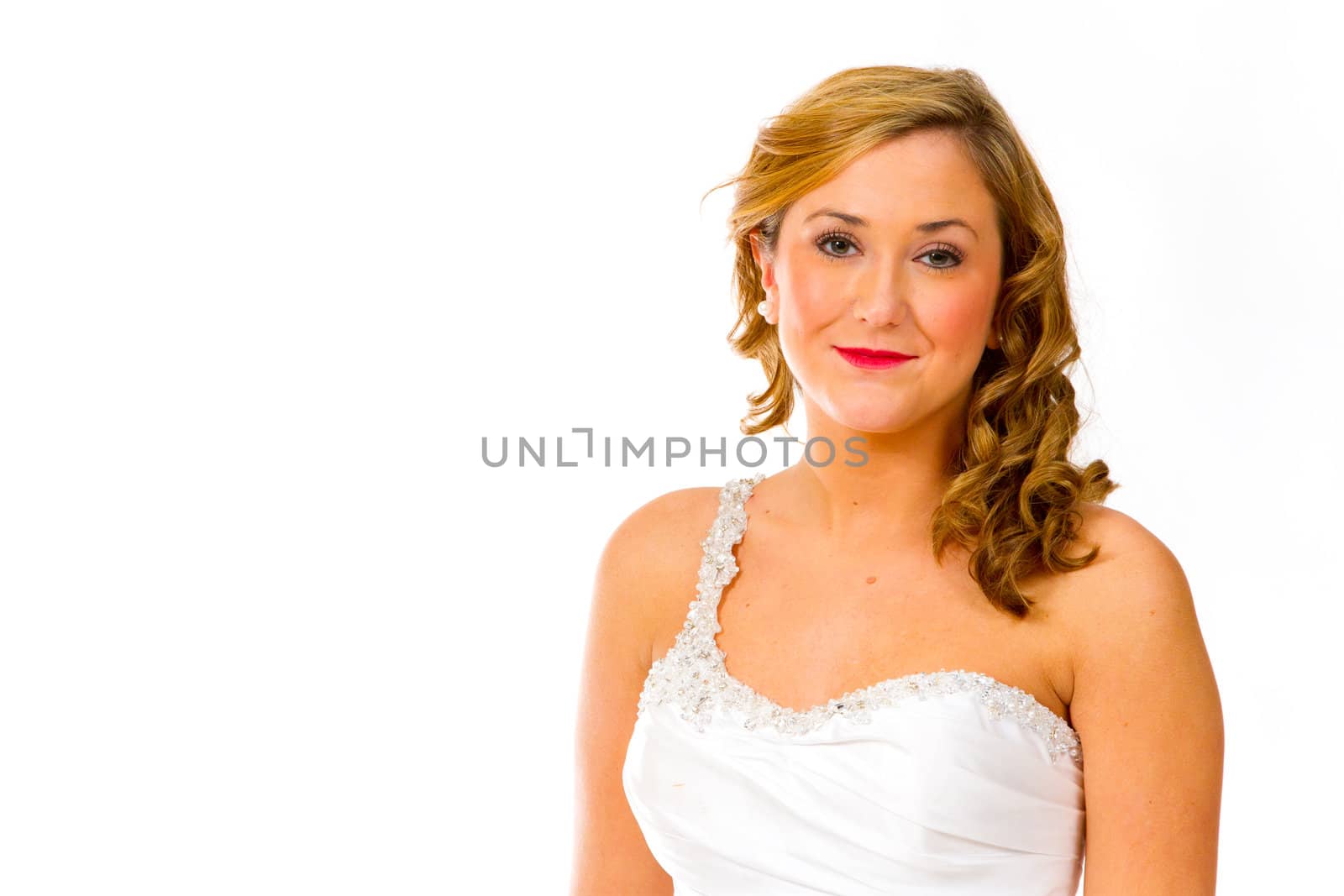 An isolated portrait of a beautiful brunette bride in the studio against a white background with her in her wedding dress.