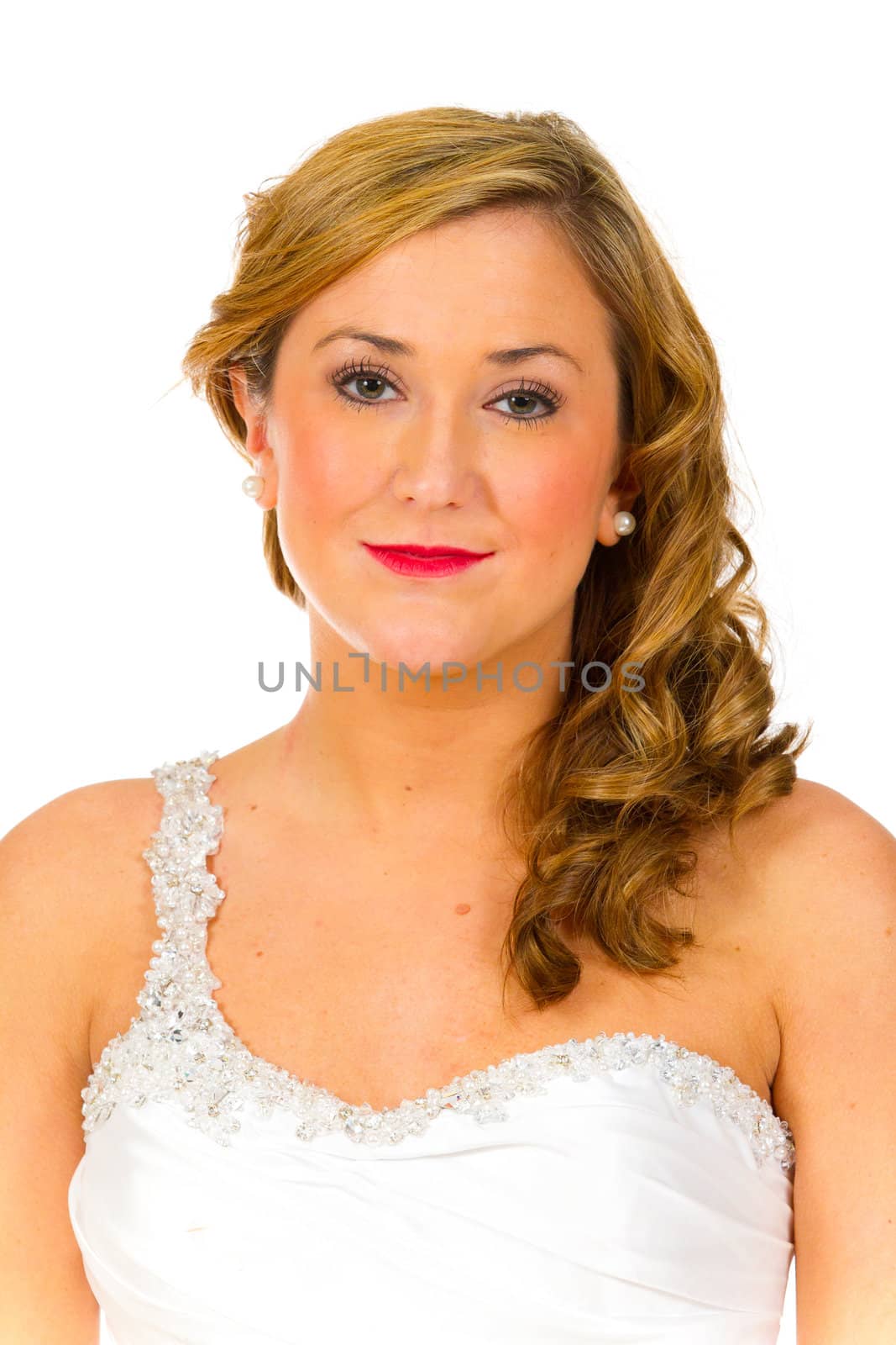 An isolated portrait of a beautiful brunette bride in the studio against a white background with her in her wedding dress.
