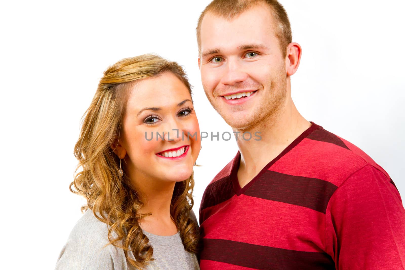 An attractive couple against a white background in the studio to create this isolated portrait.