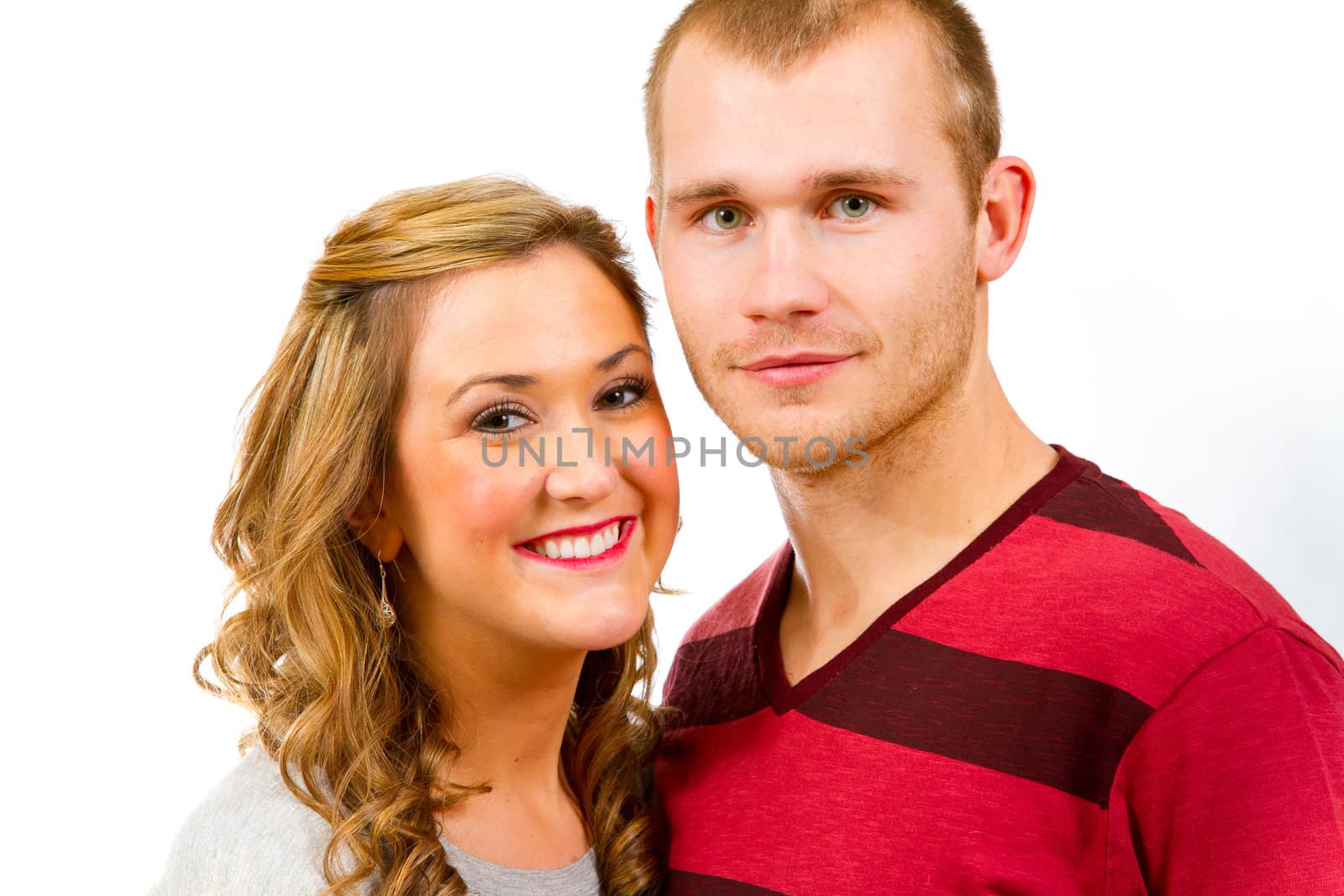 An attractive couple against a white background in the studio to create this isolated portrait.